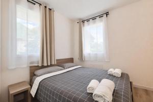 a bedroom with a bed with two towels on it at Nuovo appartamento in centro a Darfo Boario Terme in Boario Terme +34 photos