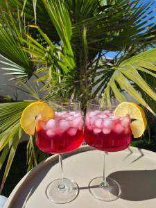 two glasses of red drink with orange slices on a table at Vila VivaVir with 2x E-Scooter, private Pool & Grill in Vir