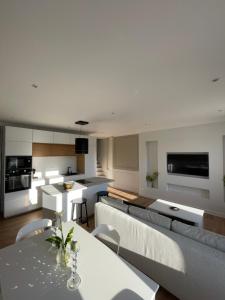 a kitchen and living room with a couch and a table at Belle escale by LV in Dieppe