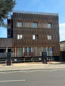 a wooden building with a bench in front of it at URBAN OAK Smart Stay in Cologne