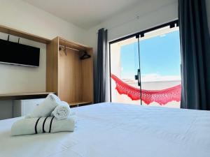 a bedroom with a large bed with a large window at 4 Ventos House in São Miguel do Gostoso +12 photos