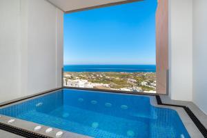 a swimming pool with a view of the ocean at Villa by Hotel Thira in Fira
