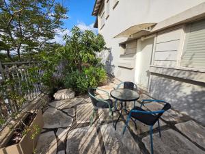 a patio with two chairs and a table on a patio at Tavor view נוף תבור in Daverat