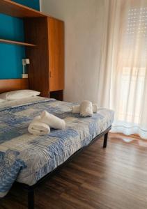 a bedroom with a bed with towels on it at Hotel Luisa in Brenzone sul Garda +24 photos