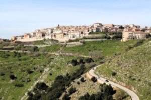 a town on top of a hill with a road at Nonna Nunzia Affitti Brevi in Rignano Garganico