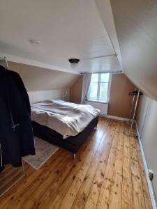 a bedroom with a bed and a wooden floor at Mörrum, Haus 2 & 3 in Mörrum