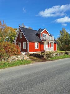 a red house on the side of a road at Mörrum, Haus 2 & 3 in Mörrum