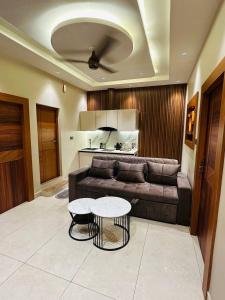 a living room with a couch and a table at Vrs Homestay in Mayiladuthurai +5 photos