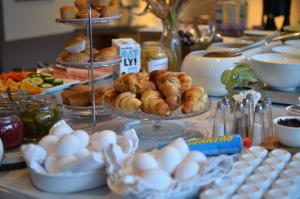 a buffet of food with croissants and pastries on a table at HOTEL N Hostel Malmö City in Malmö