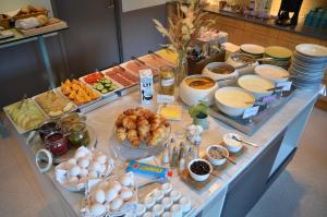 a buffet with many different types of food on a table at HOTEL N Hostel Malmö City in Malmö +46 photos