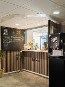 a restaurant with a black and brown striped wall at HOTEL N Hostel Malmö City in Malmö