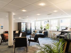 a lobby with couches and chairs and tables at HOTEL N Hostel Malmö City in Malmö