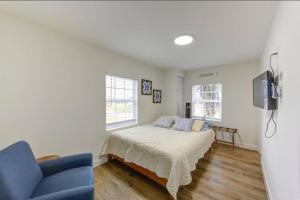 a bedroom with a bed and a tv and a couch at Palms Getaway in Freeport