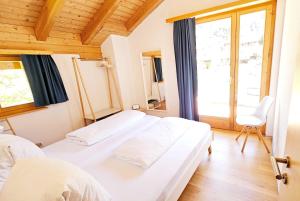 a bedroom with two beds and a window at Gästehaus auf Camping Grächbiel in Grächen +59 photos
