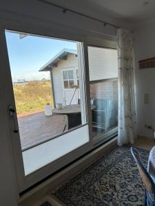 a sliding glass door leading to a deck at Haus-am-Deich in Wittdün