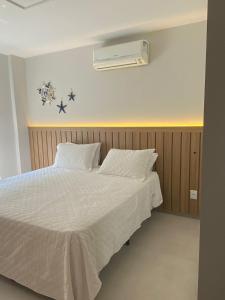 a bedroom with a white bed and a heater at Vilella Vista Bela in Angra dos Reis +53 photos