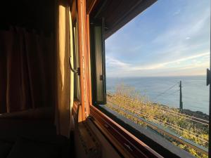 a window view of the ocean from a train at Tramonto sul Mare in Framura