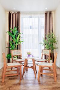 a dining room with a table and two chairs at BEN Villa in Cẩm Phả Mines +6 photos