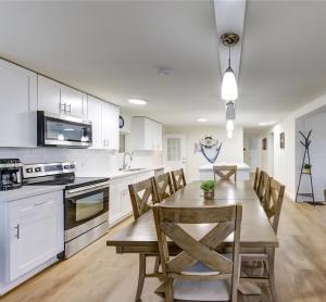 a kitchen and dining room with a wooden table and chairs at Palms Getaway in Freeport