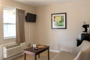 a living room with a couch and a table at Sea Horse Inn and Cottages in Nags Head