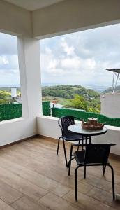 a patio with a table and chairs on a balcony at צימר החורש in Dāliyat el Karmil +3 photos