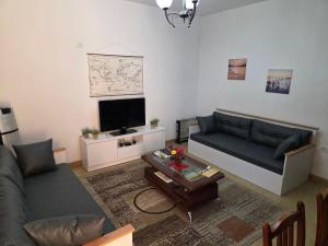a living room with a couch and a tv at Sixth Apartment in Shkodër