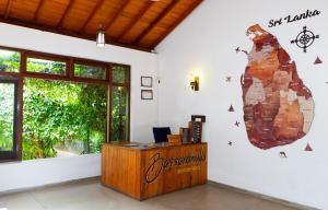 an office with a sign on the wall and a desk at Battaramulla Boutique Villa in Sri Jayewardenepura Kotte