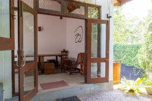 an open door to a patio with a table and chairs at Battaramulla Boutique Villa in Sri Jayewardenepura Kotte