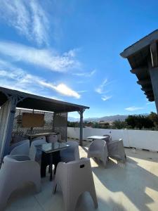 a patio with tables and chairs and a table and chairs at Santa Maria Dahab Hotel in Dahab