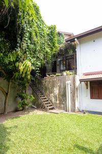 a house with a staircase leading up to a window at Battaramulla Boutique Villa in Sri Jayewardenepura Kotte