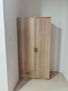 a wooden cabinet in the corner of a room at blissful well treat in Ban Madua Wan