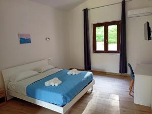 a bedroom with a bed with two towels on it at Il Borgo in Iglesias +9 photos