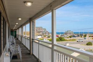 a balcony with chairs and a view of the ocean at Sea Horse Inn and Cottages in Nags Head