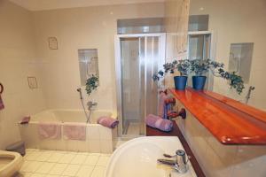 a bathroom with a sink and a shower and a tub at Casa Olaf in Cannobio