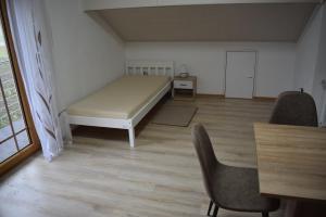 a bedroom with a bed and a desk and a chair at Monteurzimmer, Gästezimmer, Ferienwohnung in Altötting