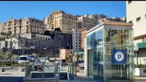 a bus stop with a parking sign in front of a city at Hotel Chopin in Genoa