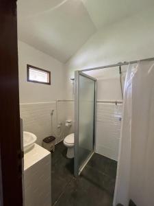 a bathroom with a shower and a toilet and a sink at Peach's House in Katiet +25 photos