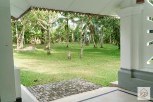 a view of a park from the outside of a house at Wimala Sewana in Veyangoda