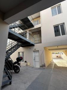 a building with a motorcycle parked in a parking lot at La Pampa Apartment in General Roca