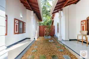 a corridor of a house with a gravel floor at Wimala Sewana in Veyangoda