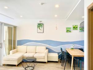a living room with a couch and a table at Ocean Dream Apartment Nha Trang in Nha Trang