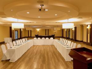 a large room with a long table and white chairs at Pullman Lubumbashi Grand Karavia. in Lubumbashi +128 photos