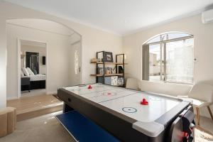 a living room with a ping pong table in it at Elysian Fields in Joondalup in Perth