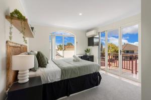 a bedroom with a bed and a balcony at Elysian Fields in Joondalup in Perth +37 photos