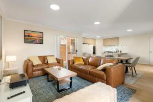 a living room with a couch and a table at Elysian Fields in Joondalup in Perth