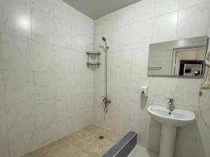 a white bathroom with a sink and a mirror at Emilia Hotel Batumi Old Town in Batumi +94 photos