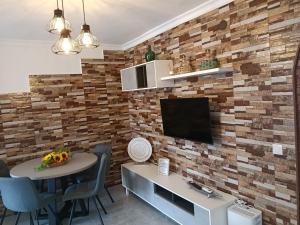 a living room with a brick accent wall at Apartamento en Torrox in Torrox