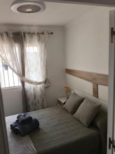 a bedroom with a bed with two towels on it at Apartamento en Torrox in Torrox