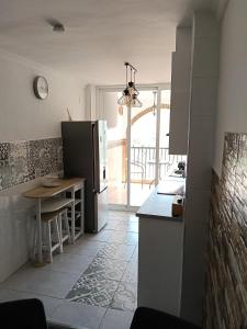 a kitchen with a black refrigerator and a table at Apartamento en Torrox in Torrox