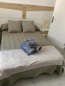 a bed with two towels sitting on top of it at Apartamento en Torrox in Torrox +8 photos